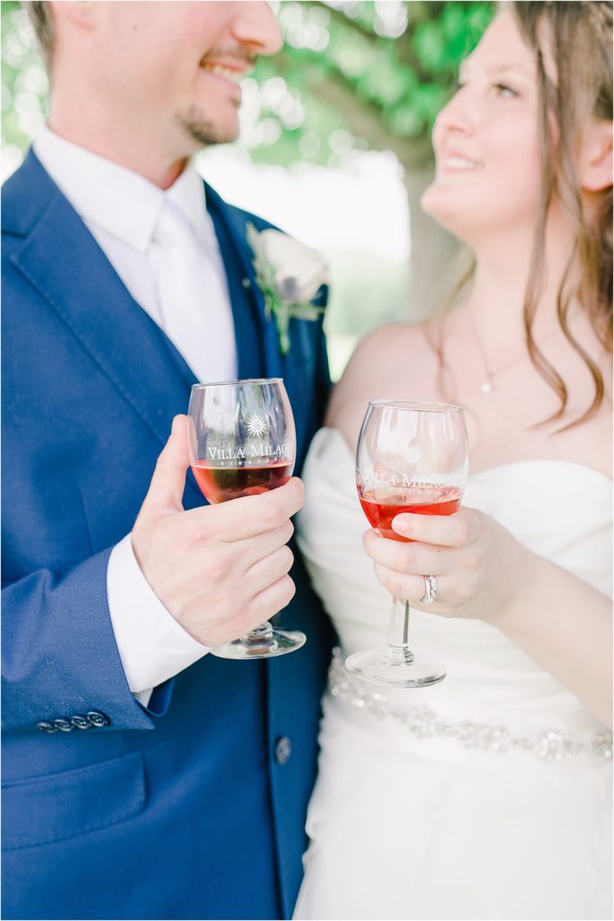 bride and groom holding wine glasses