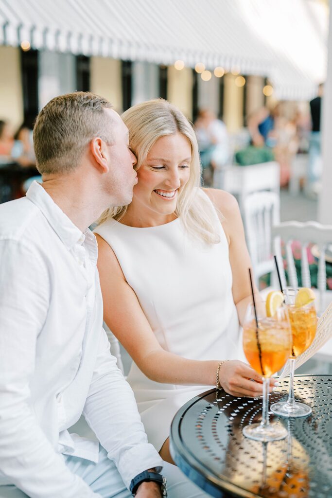 Couple sharing an Aperol spritz during their Cape May engagement session