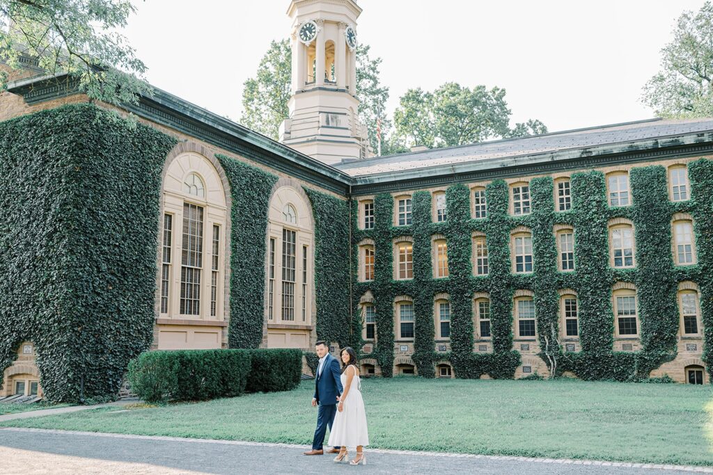 Joyful engagement photos at Princeton University NJ with ivy-covered backdrop