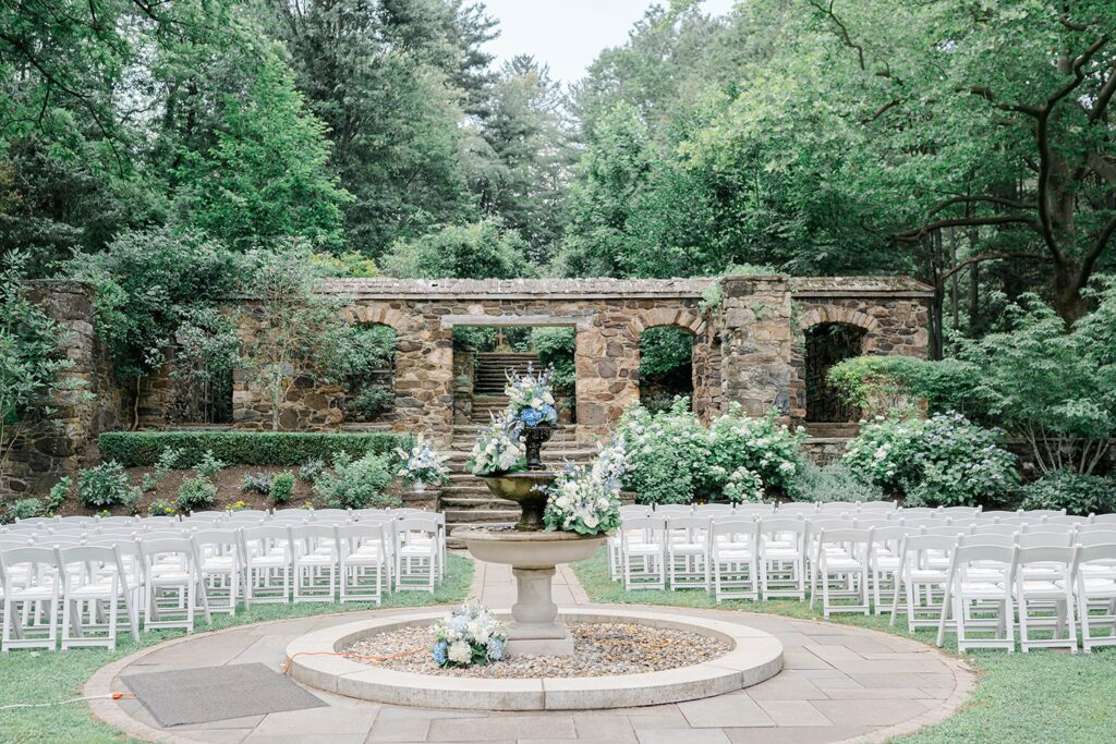 Garden ceremony by fountain with cascading florals.