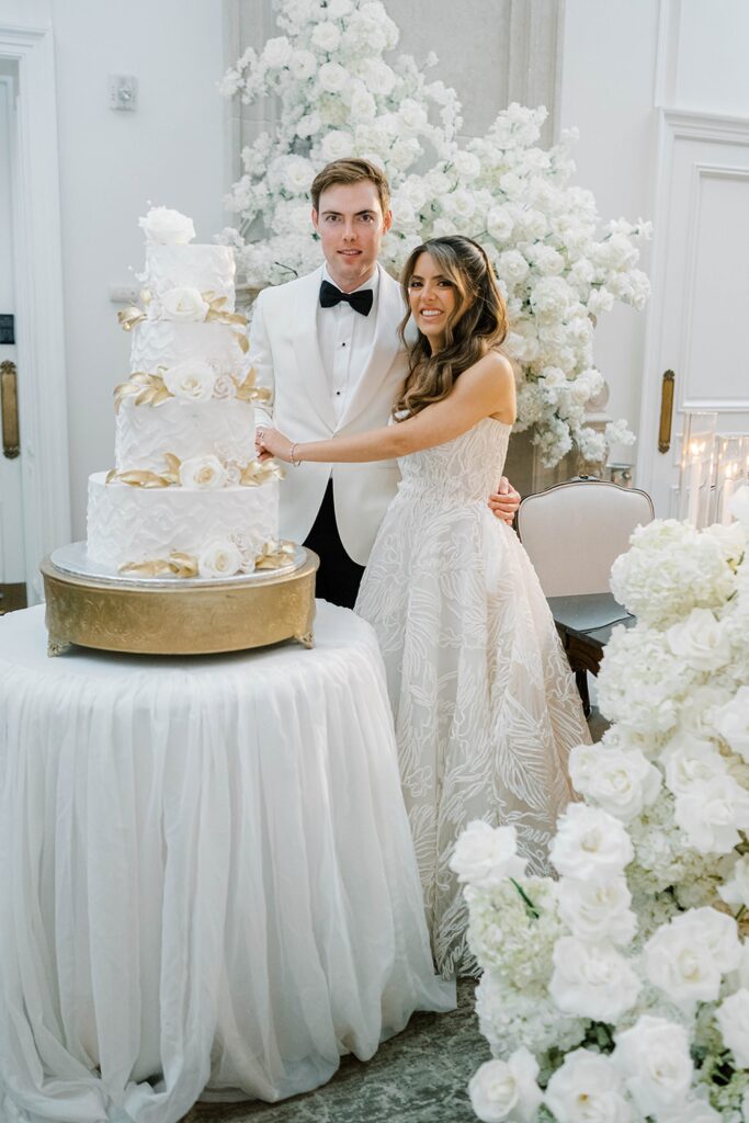 Bride and Groom cutting their wedding cake at park chateau