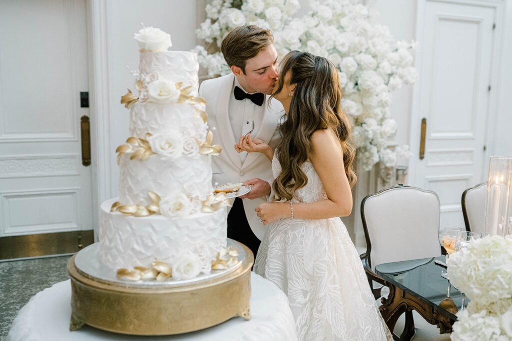 Bride and Groom cutting their wedding cake at park chateau