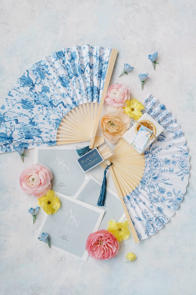 Flat lay of wedding rings and invitation details for colorful coastal wedding New Jersey