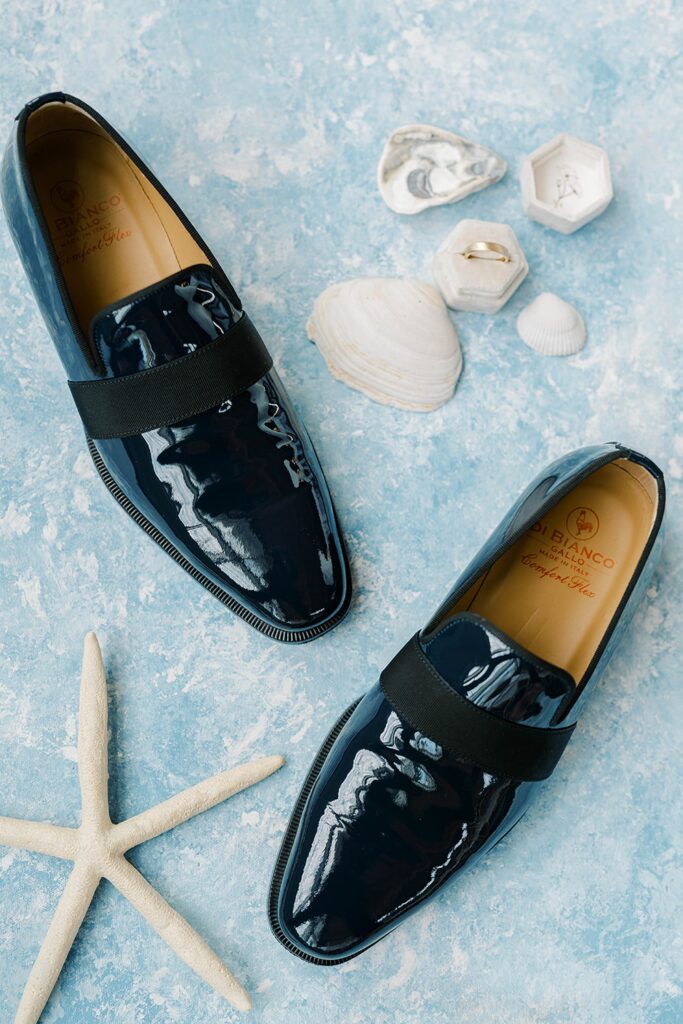 Flat lay of wedding rings and invitation details for colorful coastal wedding New Jersey