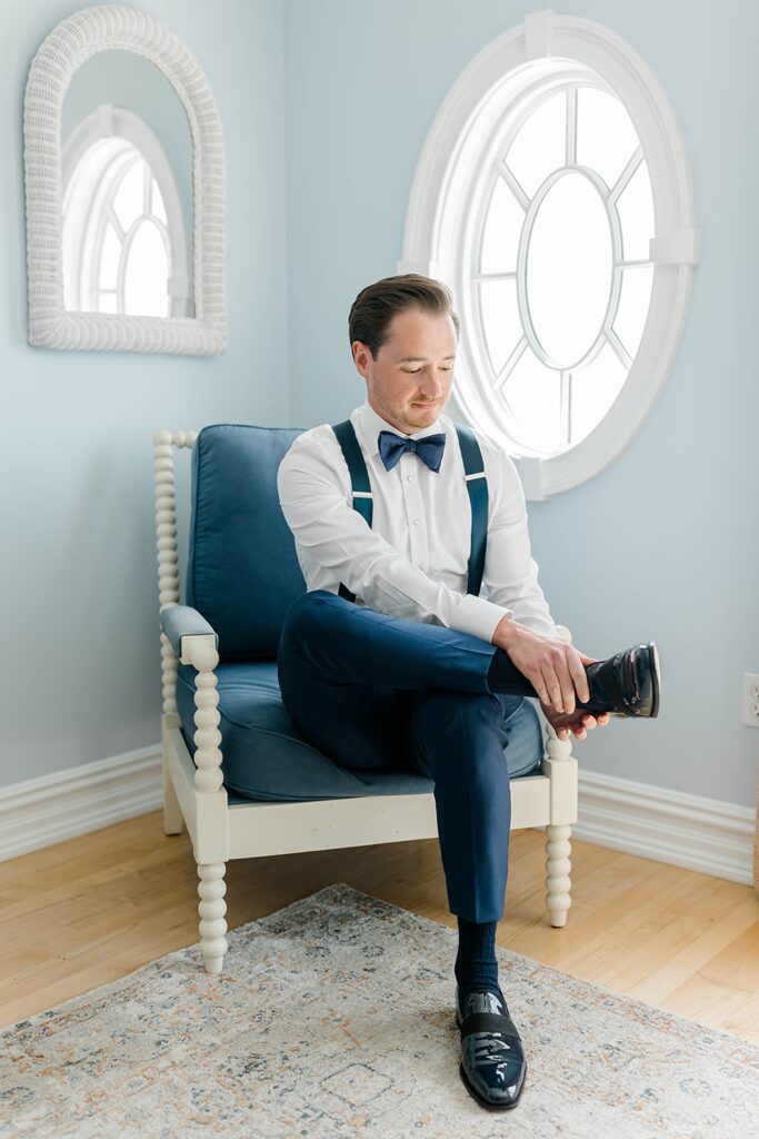 Groom portrait in navy suit at New Jersey waterfront wedding venue