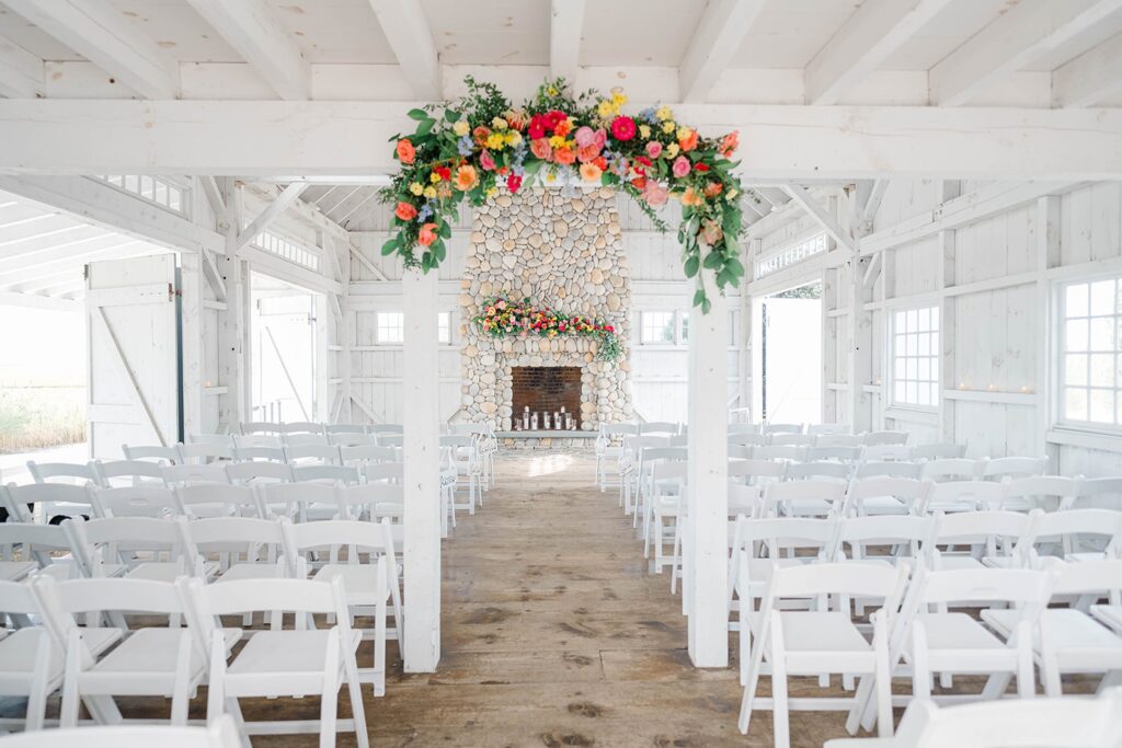 Boathouse Chapel ceremony setup with bright floral arch at Bonnet Island Estate