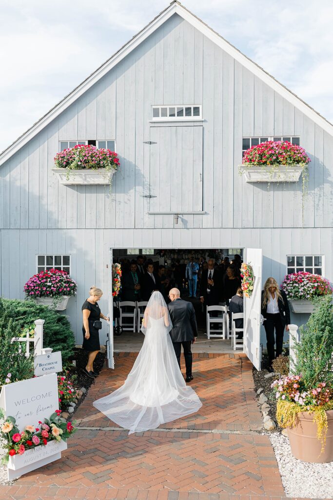 Vibrant coral pink yellow orange floral ceremony arch by MDS Floral Long Beach Island