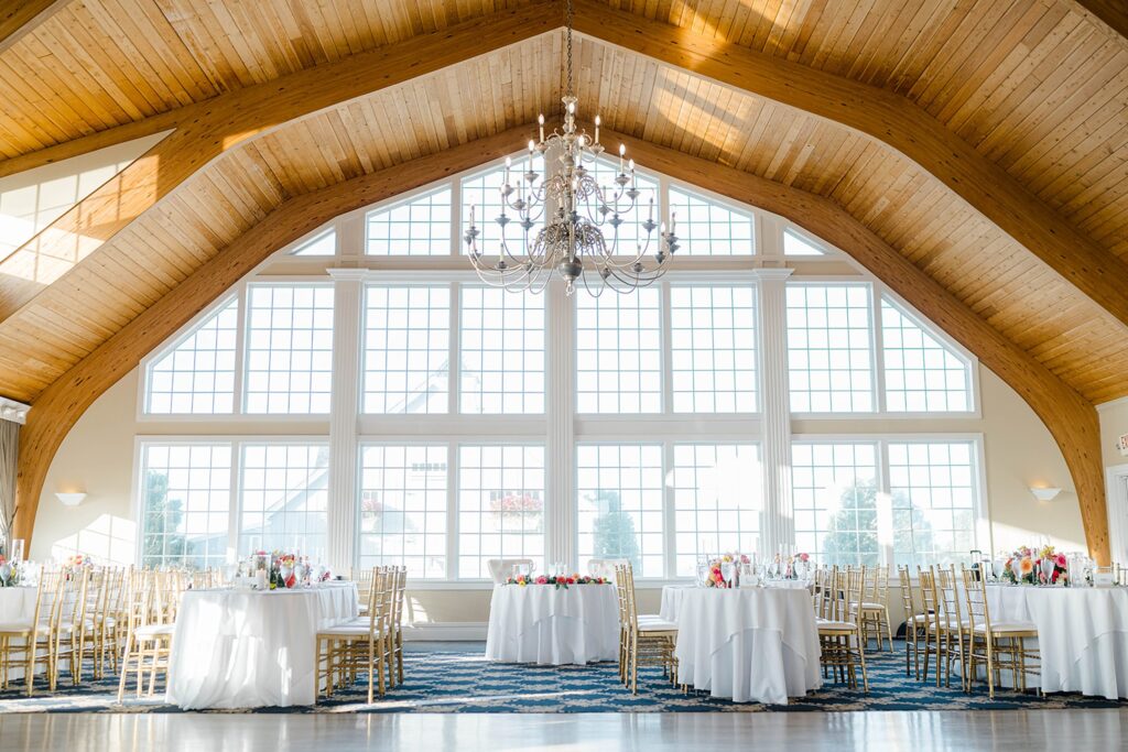 Reception room with bright floral table runners at Long Beach Island wedding
