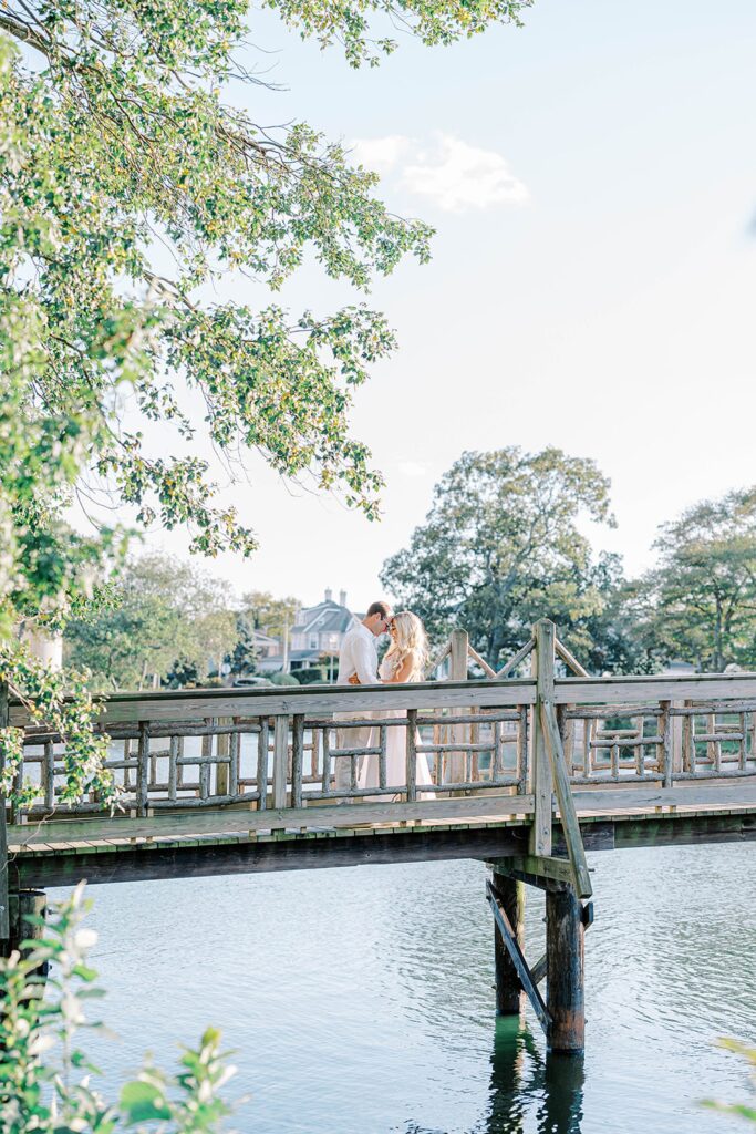 New Jersey Spring Lake beach engagement session on wooden bridge at Divine Park