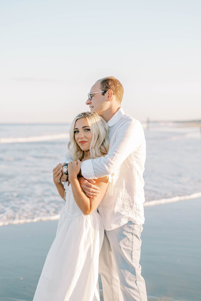 Sea Girt beach engagement photos couple dancing on sand at golden hour