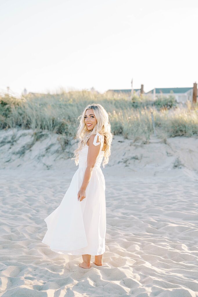 Sea Girt beach engagement photos couple dancing on sand at golden hour
