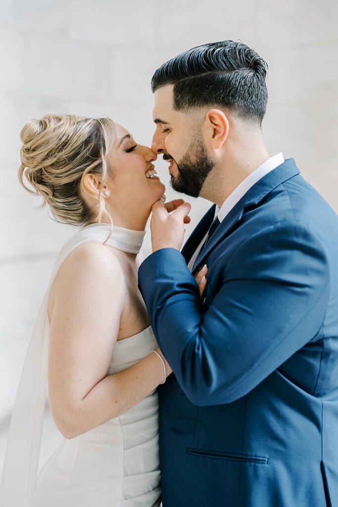 Stefanie leaning into Giovanni on the grand marble steps of the New York Public Library, NYC engagement portrait.
