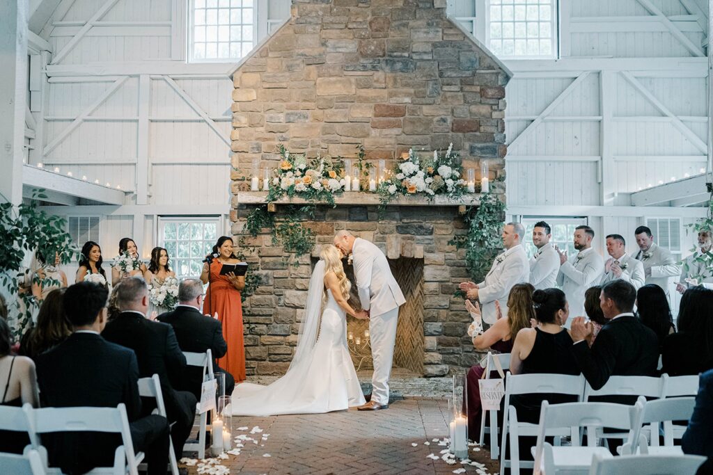 First Kiss during the wedding ceremony in the barn at the Ashford